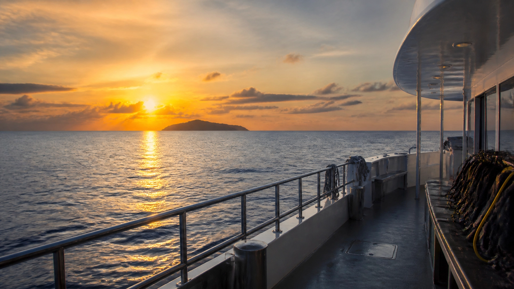 A sunset view from the deck of a luxury liveaboard dive boat