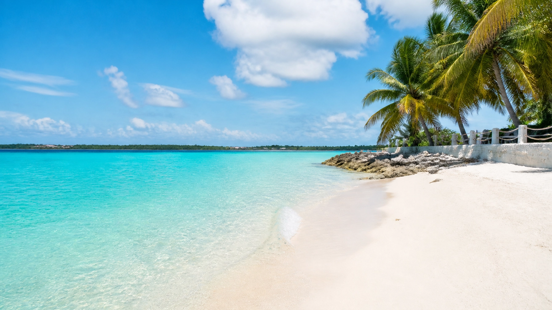 A bright tropical beach in the Cayman Islands with crystal clear water, white sand, and a clean, natural-light travel look.