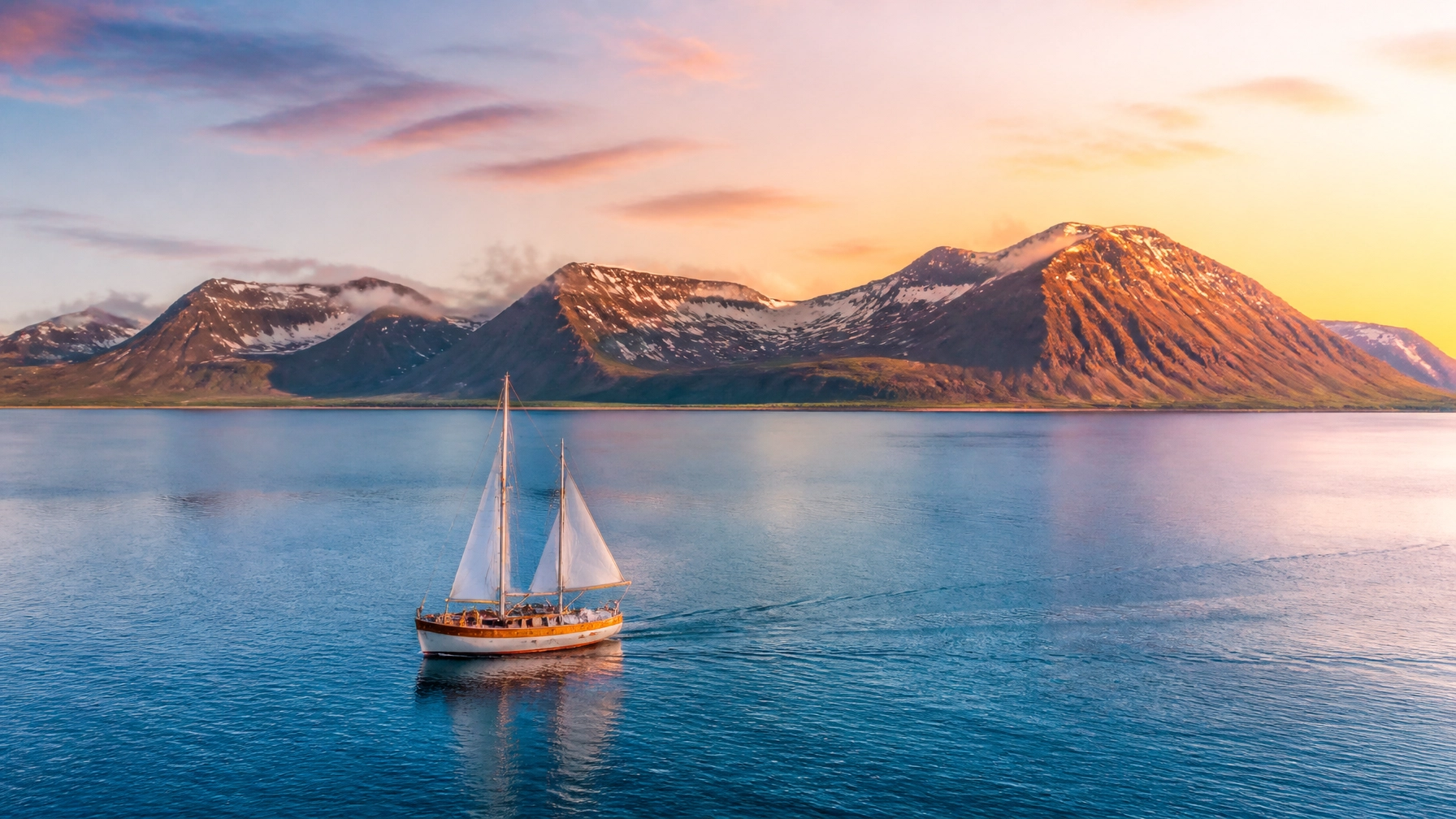 A traditional wooden sailboat gliding through an Icelandic fjord under the midnight sun