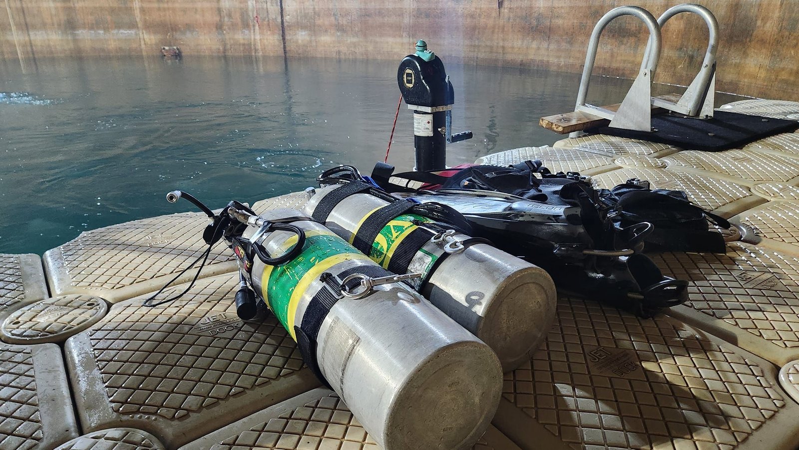 A diver preparing gear on a boat.