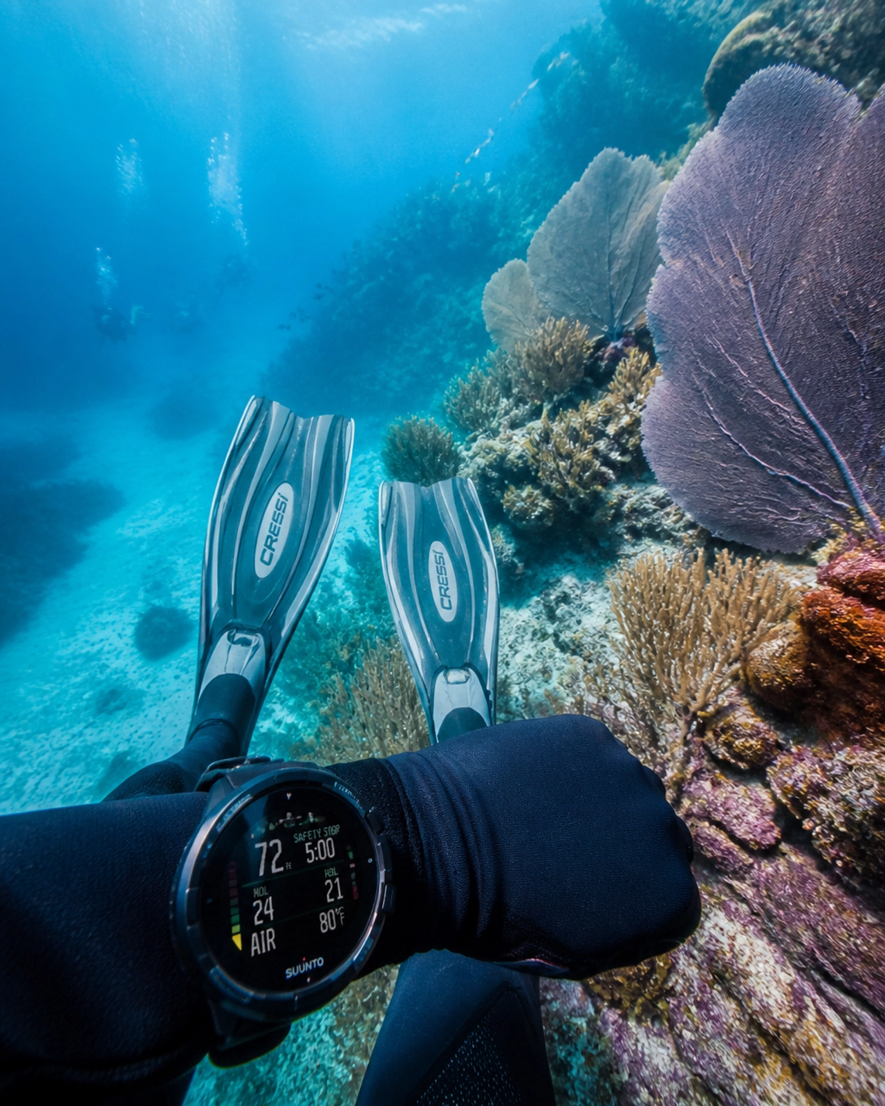 A scuba diver exploring vibrant soft corals in the clear waters of Roatan
