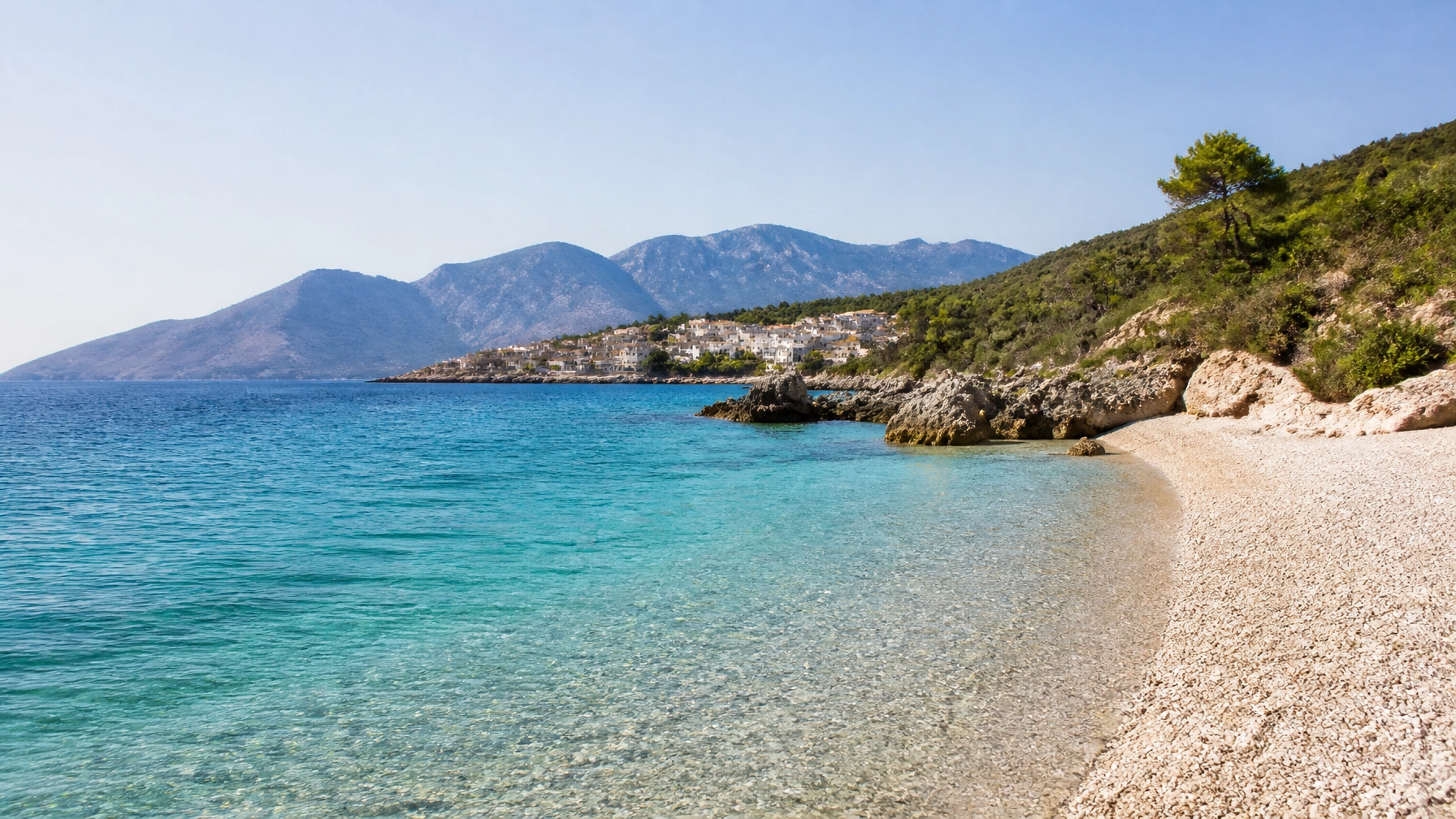 Stunning coastal view of the Albanian Riviera with turquoise water and white pebbles